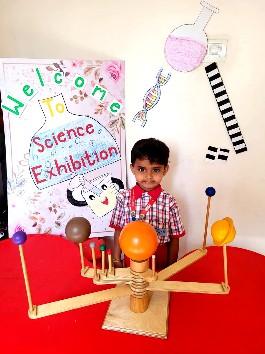 Young scientist presenting a solar system model at our science exhibition