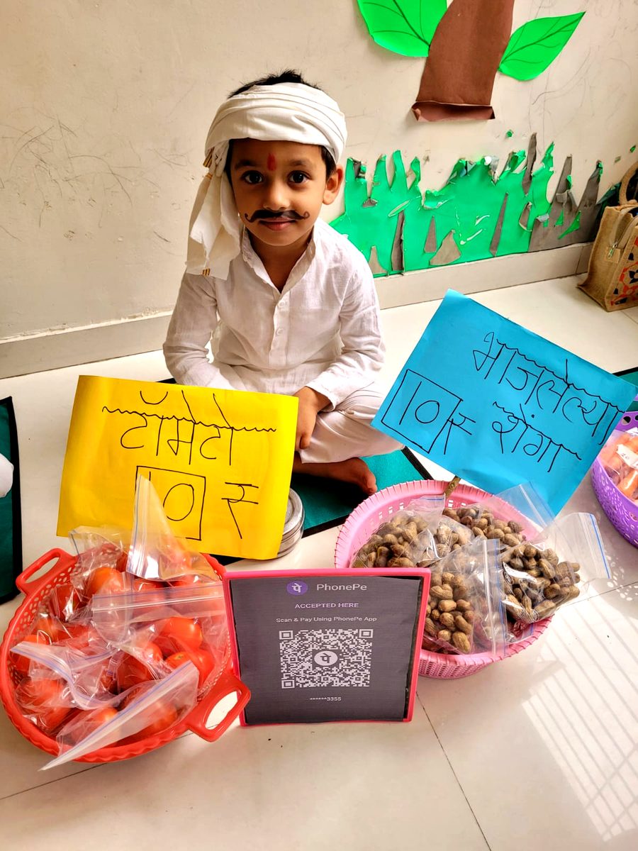 Children running a pretend market stall during role-play learning